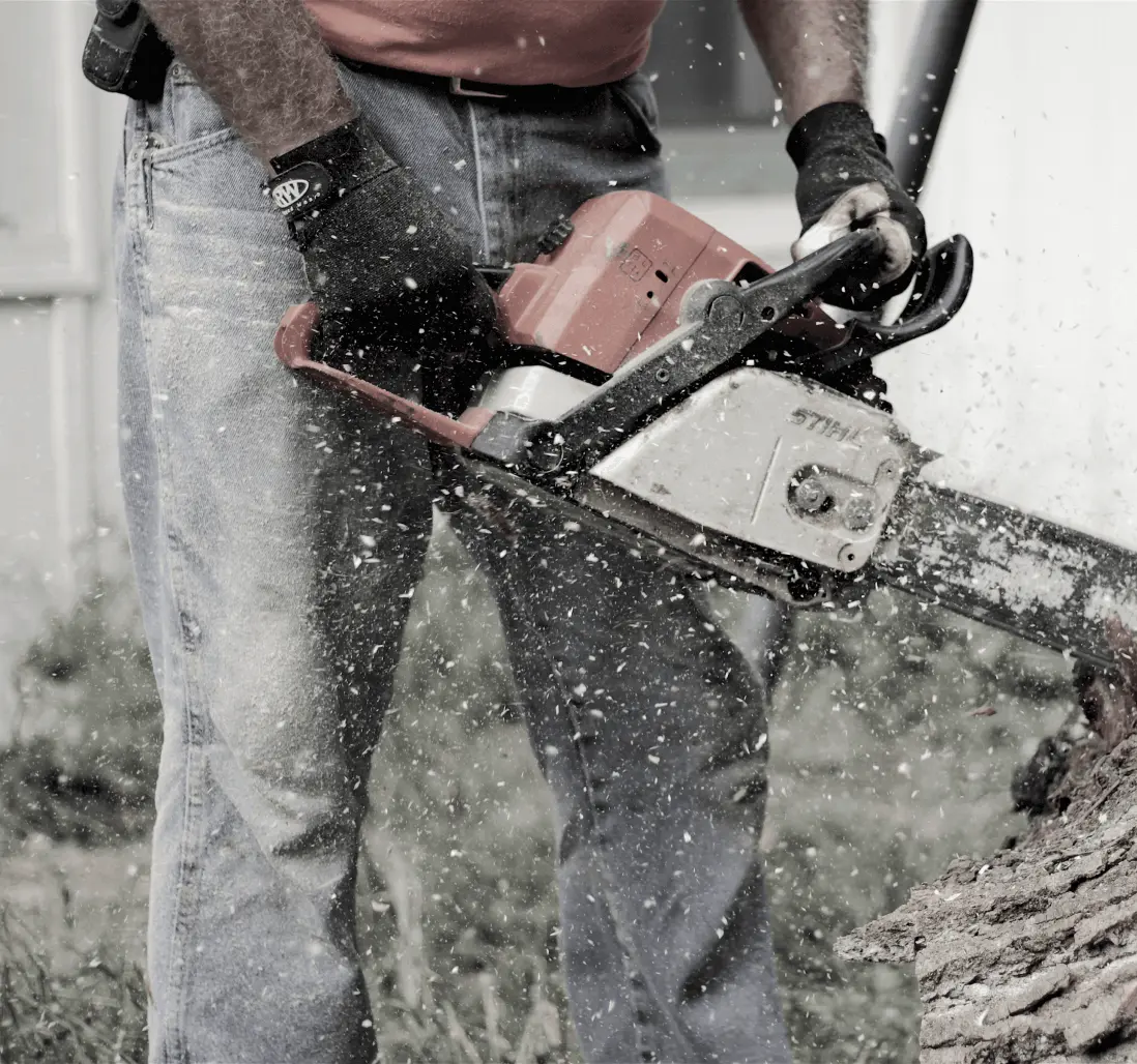 Man cutting a log with a chainsaw